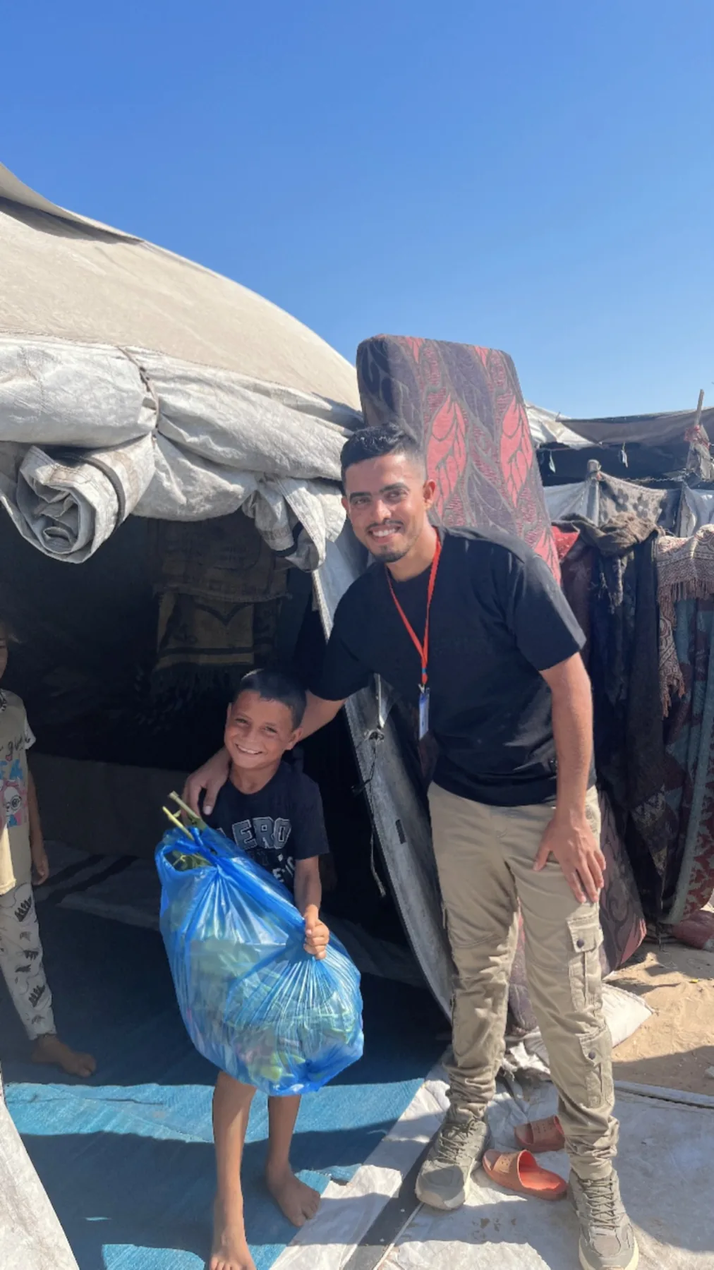 Child holding a bag of fresh food assistance